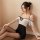 A woman poses in a black and white silk-look lace sheer secretary outfit, featuring a seductive hollow-out design, ruffled he...