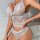 Woman wearing elegant white lace lingerie set with cami top and shorts, stylish at-home loungewear for women.
