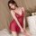 Woman wearing red lace sleepwear set, sheer transparent slip dress with delicate straps, elegant bedroom lingerie for women.
