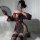 A woman poses in a black lace kimono-style robe with floral patterns, off-shoulder design, sheer fabric, and thigh-high stock...