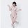 A woman models a white fuzzy christmas costume featuring a snowman-themed bikini set with black polka dots, red accents, and ...
