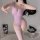 A woman poses wearing a sheer lavender one-piece swimsuit with thigh-high stockings, highlighting its elegant design and femi...