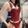 Woman wearing red lace corset bodysuit with fishbone mesh detailing and garter straps.