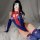 Woman wearing a sexy spider-man cosplay bodysuit with open-crotch design, featuring blue and red colors, spider emblem, and t...