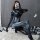 Woman posing in a black spider-man role play costume, a sexy tight-fit open-crotch bodysuit for adults.