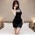 A woman poses elegantly in a black spring mountain dream lingerie set, featuring a sexy chinese-inspired robe with ties, perf...