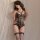 A woman poses in a black lace bodysuit with open crotch design, featuring crisscross straps and fishnet stockings, ideal for ...