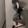 Woman in a striped sexy secretary outfit with high heels, posing seductively.