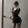 Woman in striped sexy secretary outfit with matching lingerie, holding a riding crop while taking a mirror selfie.