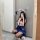 A person wearing a cute bunny headband, taking a mirror selfie. theyre dressed in a playful school uniform outfit featuring a...