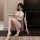 Woman wearing sugar island seductive lingerie set – modest lace bodycon dress with high heels, posing elegantly indoors.