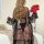 Woman in sheer polka dot robe holding red roses, wearing matching lace bra and panty from sultry polka dot lace sleepwear set...