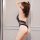 Woman wearing black sheer lace bodysuit, hot summer lingerie set with tight-fit erotic design, -style sexy outfit for women.