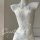 White sheer lace bodysuit with floral embroidery on mannequin, styled with pearl necklace for romantic bedroom wear.