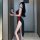 Woman in black sheer cheongsam lingerie with red accents and high slit, posing by a door. suoqing erotic role play outfit for...