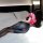 Woman in suoqing cosplay lingerie, anime-style seductive outfit with dual zippers and open-crotch design, posing on bed.