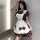 A woman poses wearing a maid-themed dress, featuring a cream and brown color scheme with ruffles and bows, perfect for anime ...