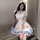 A woman wears a charming maid lolita dress with pastel pink and blue accents, featuring ruffles and bows, perfect for anime-t...