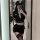 Woman in suoqing police uniform lingerie set with short skirt, crop top, and hat, posing for mirror selfie.