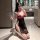 Woman kneeling in bathroom wearing suoqing floral rose lingerie dress with deep v neckline and high slit, holding lace fan.