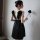 A woman models a black suoqing sensual lingerie set, featuring a strapless design with feathered wings on the back, perfect f...