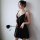 A woman poses elegantly wearing a black suoqing sensual lingerie set, featuring a strapless design with a deep neckline and f...
