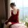 A woman elegantly poses in a luxurious red suoqing sensual lingerie set, featuring a deep v-neckline and delicate winged stra...