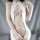 White sheer bodysuit with cross-back design, revealing back and cheek areas, perfect for women seeking elegant yet daring swi...