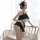 A woman poses in a black and white sheer maid costume with cat ears, featuring an open-crotch design, ideal for small bust wo...
