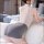 Woman wearing suoqing sexy lingerie set – sheer mesh top and bodycon skirt, posing on bed in elegant, tempting secretary styl...