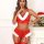 Woman wearing red lace lingerie set with white fur trim and garter straps in festive holiday setting.