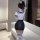 Woman wearing suoqing sexy navy collar sheer bodysuit and pencil skirt set, posing in modern room with white sofa.
