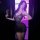 Woman wearing suoqing sexy v-neck low-cut lace sheer slip dress with full rhinestone embellishment, holding a red rose.