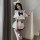 A stylish outfit featuring a sailor-themed top with ruffled sleeves and a large bow, paired with a pleated mini skirt and mat...