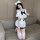 A stylish young woman poses wearing a cute sailor-themed cosplay outfit, featuring a white top with ruffles, a navy bow tie, ...