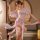 A woman elegantly poses wearing a delicate pink vintage-style lingerie set inspired by hanfu, featuring floral designs and fl...
