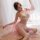 Vintage sheer lingerie set featuring pearl-embellished belly dance bra and tassel skirt, exuding exotic elegance.