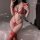 Woman modeling red suqing lace bodysuit set with open-crotch design, floral lace details, and matching thigh-high stockings.