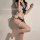 Woman modeling suqing jk uniform set with sailor-style top, lace trim, and matching garter lingerie in navy and white.