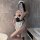 Woman modeling suqing sexy lace maid costume set with halter neck, frilly apron, and black lace detailing in bathroom mirror ...
