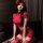 A woman poses in a red sweet fa fa sexy lingerie set, featuring an ultra-short bodycon skirt and a pure temptation tight tee,...