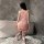 A woman stands by a bathtub wearing a pink sweet japanese maid costume, featuring delicate lace details and a soft skirt, per...