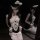 A woman models a sweet maid costume set featuring lace, bows, and adjustable straps, perfect for small bust women seeking a f...