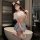 Woman modeling sweet & sexy jk uniform set - high-end lingerie outfit with crop top and pleated skirt, posing by a bathtub.