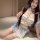 A woman poses wearing a charming sweetheart maid costume, featuring a frilly top with lace details and matching skirt, perfec...