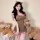 A woman wears a cute, plush bodysuit skirt with cat ears and ruffled details, holding a teddy bear. the set features playful ...