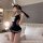 Woman wearing tangdao sensual lingerie set - navy sailor-style sleepwear with white bow, bunny ears, and lace-up sides in bed...