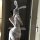 Woman in taoxitang sexy lingerie set with sheer lace sleep dress, bunny ears, and gloves posing seductively.