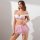 A woman models a temu lingerie set featuring a white lace bra with off-the-shoulder design and a pink floral mesh mini skirt,...