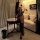 Woman in tonaer sexy lingerie yoga set with dual-zip design, sheer fabric, and feather accessory in elegant room.